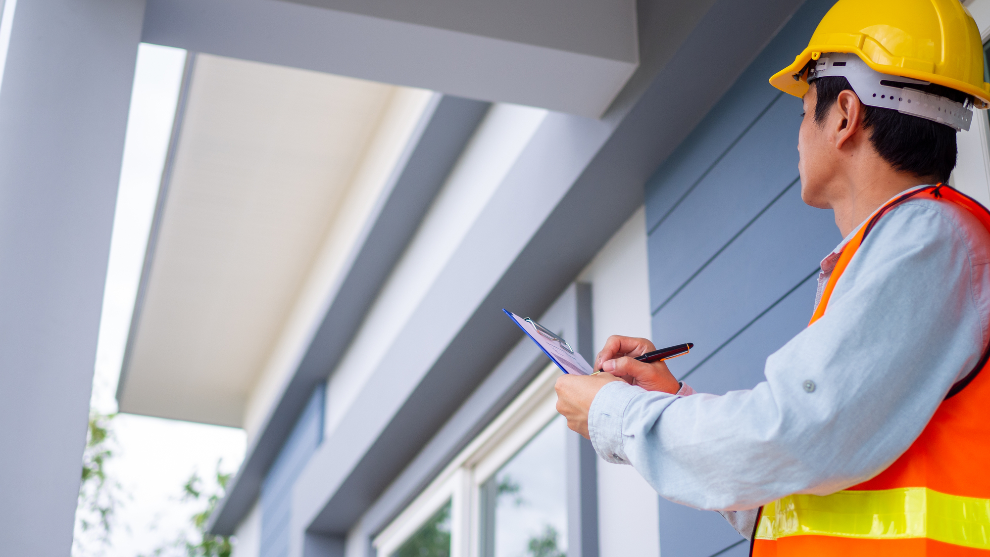 The inspector or engineer is checking the building structure and house roof specifications.